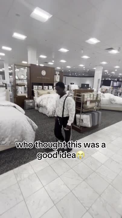 Guy Breaks Glass While Attempting to Jump on Bed in Store