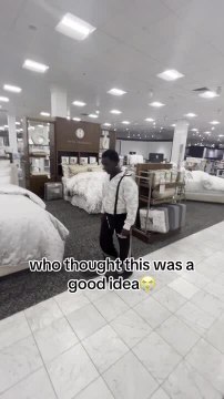 Guy Breaks Glass While Attempting to Jump on Bed in Store