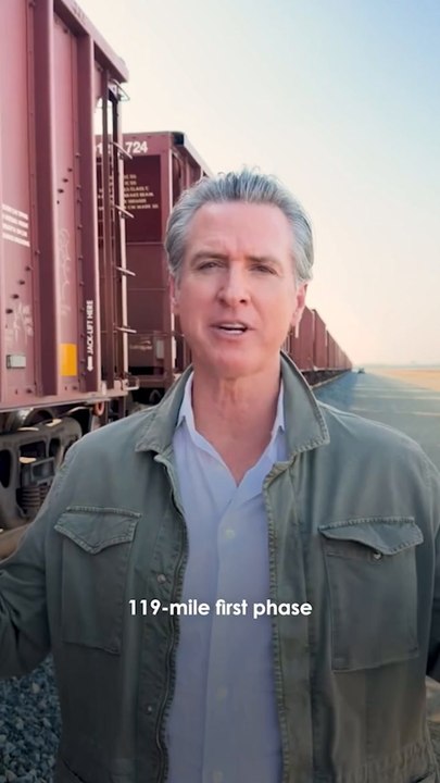 Newsom poses by freight train to tout high speed rail