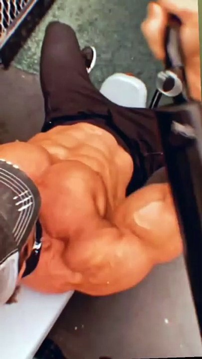 .A man does an intense workout for his chest.