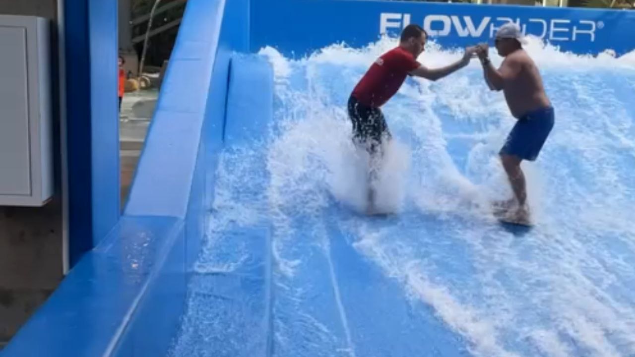 FlowRider surf goes wrong: Dad falls and takes a staff member down with ...