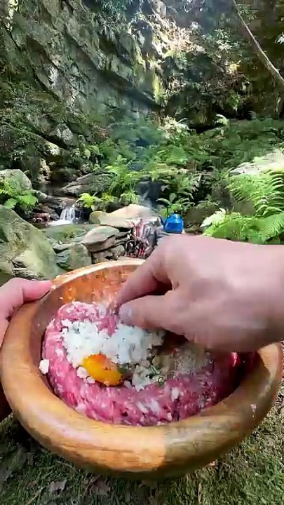 cooking potatoes with meatballs on a tile