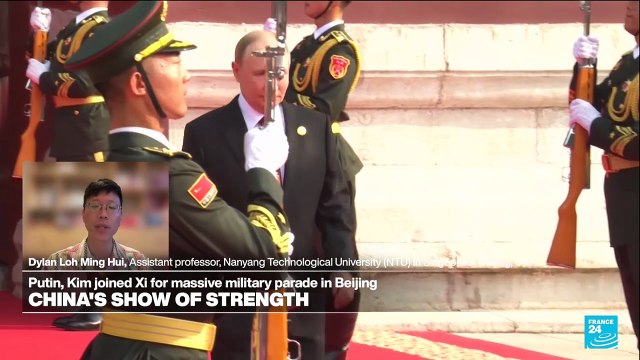 Dual message: Exerting military might, Xi says China's role is 'making, securing, protecting peace'