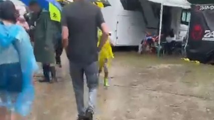 Woman walks back to camper on a wet path and meets a fall