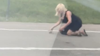 Woman picks up turtle to save it and gets a wet surprise instead