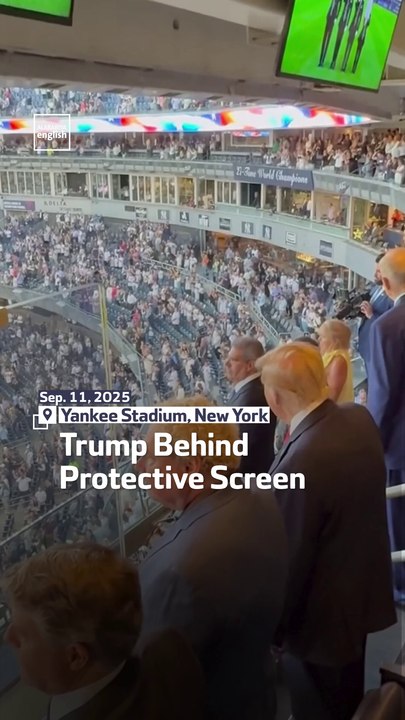 Trump Behind Protective Screen