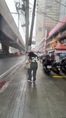Umbrella Flips Inside Out as Strong Winds and Rain Hit Manila, Philippines