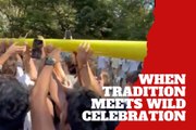Georgia Tech fans celebrate by taking the goalposts to the river