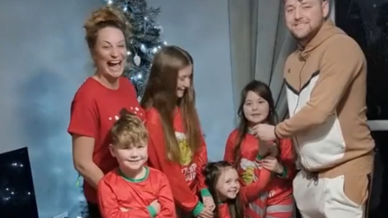 Woman filming family photo is left stunned by surprise proposal from her partner