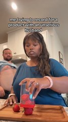 Husband Walks Past With Shirt Rolled Up While Wife Films Video