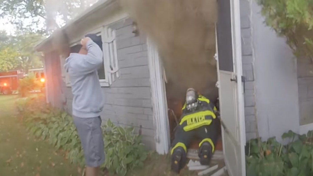 Firefighter crawls through smoke and broken glass to rescue elderly man from house fire