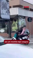 Carona de moto transporta bebê como se fosse mochila