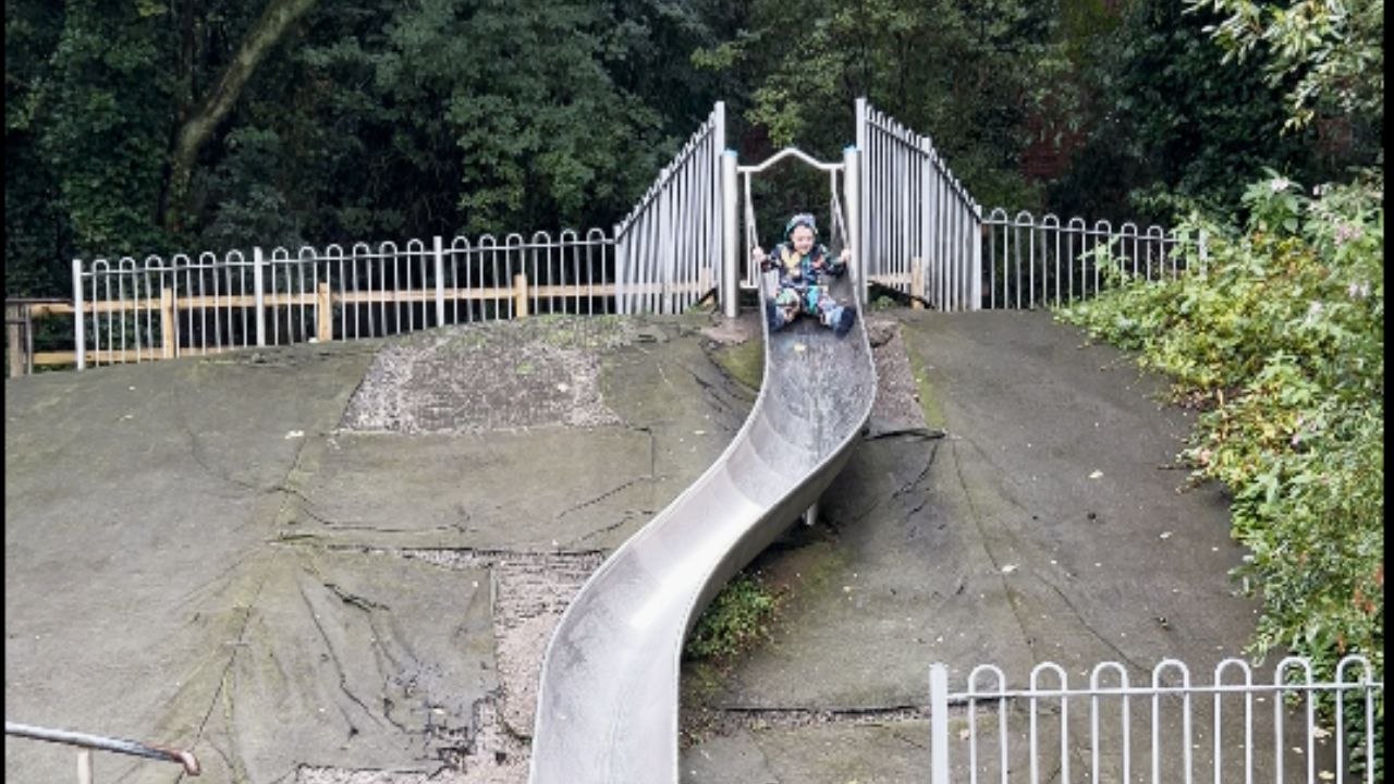 Little boy slides down a wet slide despite being warned and falls