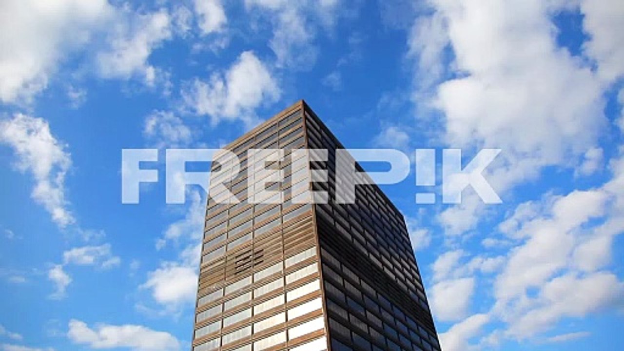 Looking up at a tall building in the clouds that could be kingpins hide out or a highly respectable Office