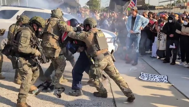 Protester with Captain America shield bundled into ICE facility in Chicago after throwing back tear gas canister
