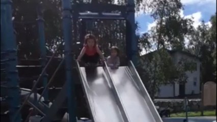 Determined toddler tries multiple times to perfect her landing at the end of the slide
