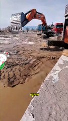 Excavator cleans mud in river
