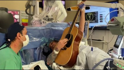 Dad plays guitar during brain surgery