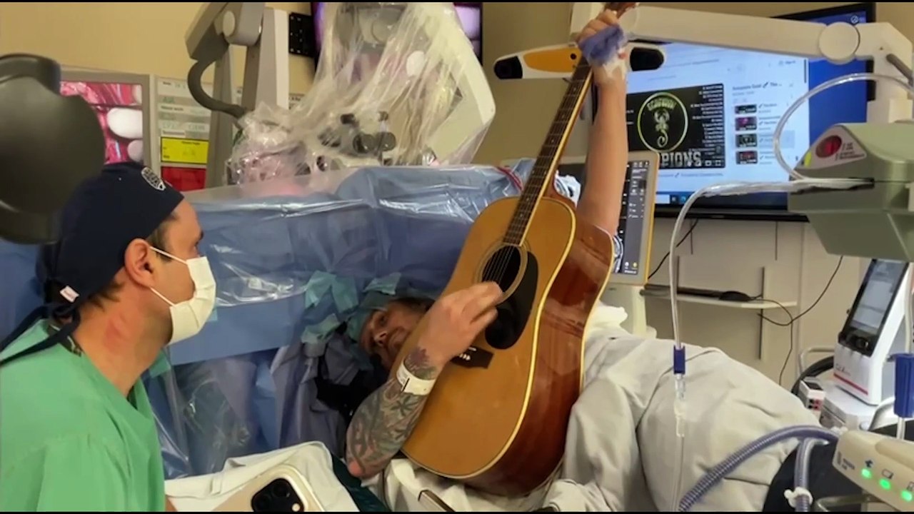 Dad plays guitar during brain surgery