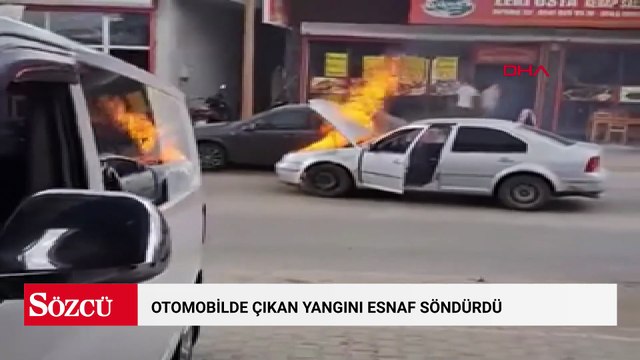 Otomobilde çıkan yangını esnaf söndürdü