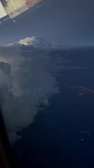Lightning Illuminates Clouds From Airplane Window