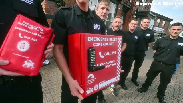 Firefighters install a Bleed Kit on The White Lion pub in Sedgley, after raising the money for it thrugh a charity car wash.