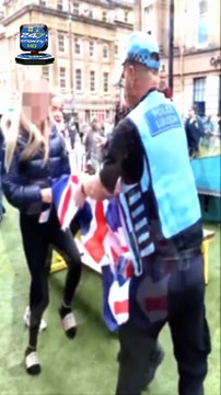 Police officer who ripped Union Jack flag from anti-migrant protester is accused of 'two-tier' policing as Palestinian flags go undisturbed