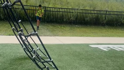 Young boy runs in a Ninja Warrior-style playground and ends up falling
