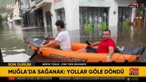 Fethiye'de yollar göle döndü, botla ilerliyorlar