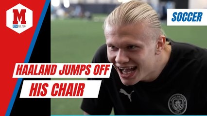 Haaland jumps off his chair after scoring for Manchester City in a videogame