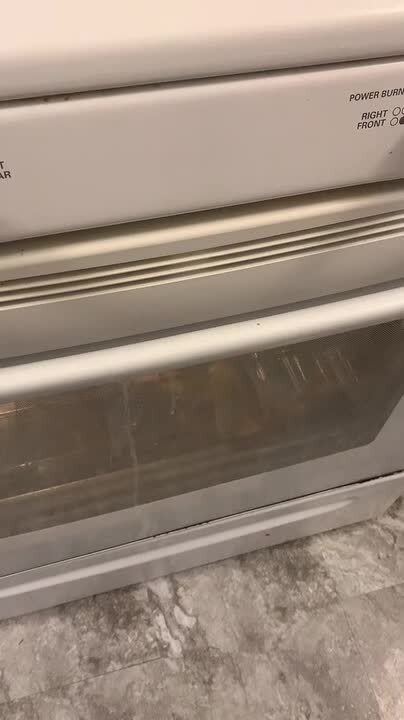 Person Opens Oven to Find Pizza Burned and Falling Over