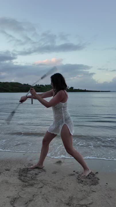 Woman Shows off Nunchuck Skills on Beach