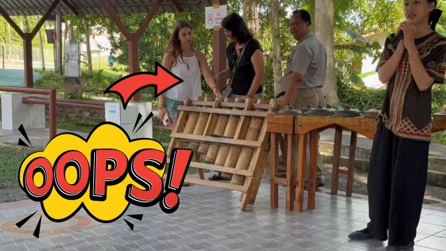 Woman trips slightly and sends a tour guide crashing to the ground