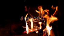 Bright fire on dark background. Wooden logs burning in beautiful vivid fire in fireplace.