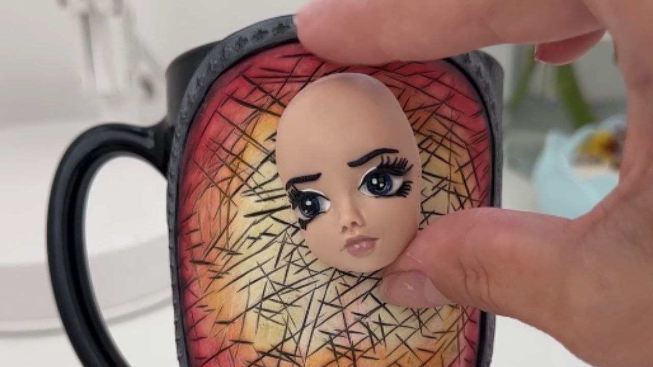 Ukrainian artist showcases polymer clay sculpting skills by using a mug as her canvas