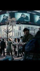 The moment the young man shouts "Bang! Bang!" in the middle of the crowded intersection as people are starting to fall around him.