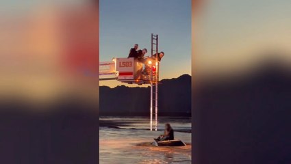 Man and baby rescued from roof of car as sweeping floodwaters surround vehicle in dramatic video
