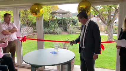 Sir Mel Stride MP cutting the ribbon at Summerhayes Care Home's grand renovation opening (Will Goddard, Crediton Courier)