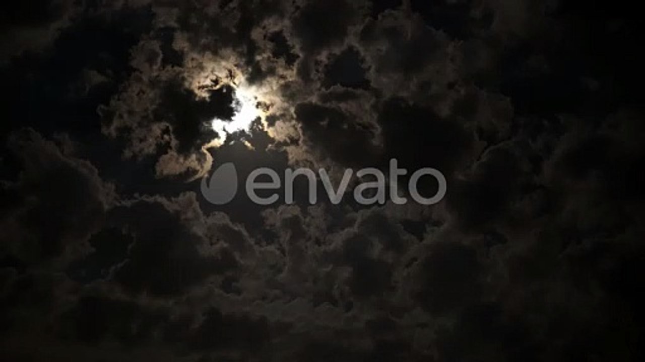 Full moon in the clouds at night.