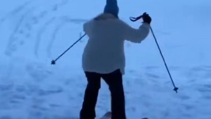 Girl tries skiing for the first time and ends up falling in snow