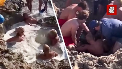 Horrifying moment kids get stuck in sand hole before beachgoers pull them out
