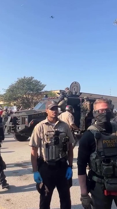 Armored vehicle rolls past protestors outside suburban Chicago ICE facility