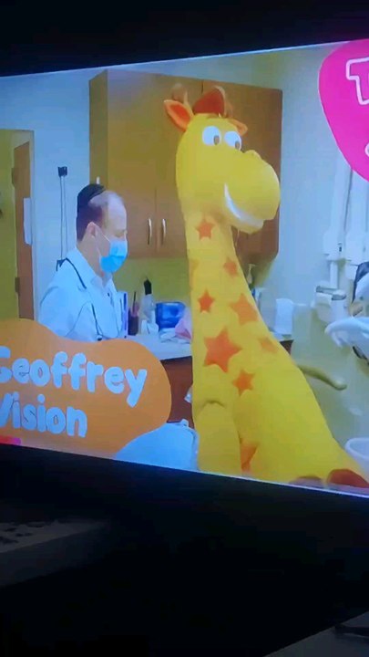 Geoffrey's Vision/Toys R Us Studios Geoffrey the Mascot Giraffe and the Dentist are Hugging