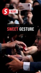 Timor-Leste PM Gusmao hands out sweets to media at Asean Summit