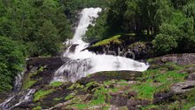 A beautiful waterfall in the Geiranger fjord, Norway. Turbulent white-water rushing down the rocks i