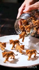 A man gently pours food from a jar for adorable lion cubs. The cubs happily eat and play around the plate — their excitement and joy will melt your heart! 🐾🍽️