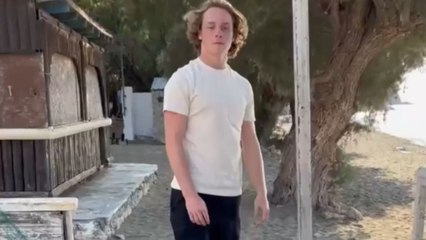 Lad throws the bottle away as his sister wins the bottle flip challenge