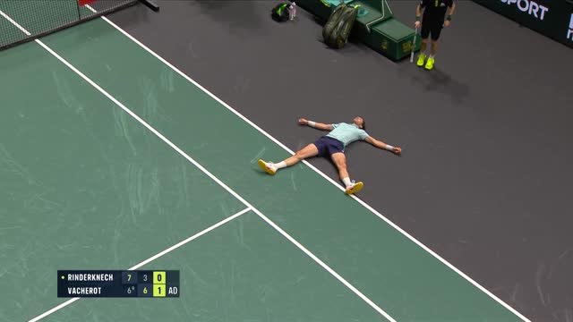 Rinderknech falls to the floor after long rally with cousin Vacherot