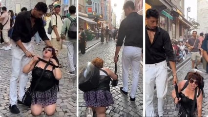 Tasma taktığı kadını sokakta gezdirdi