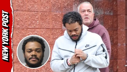 Jawarren Booker, facing first-degree rape and burglary charges, is escorted out of a Suffolk Co. precinct